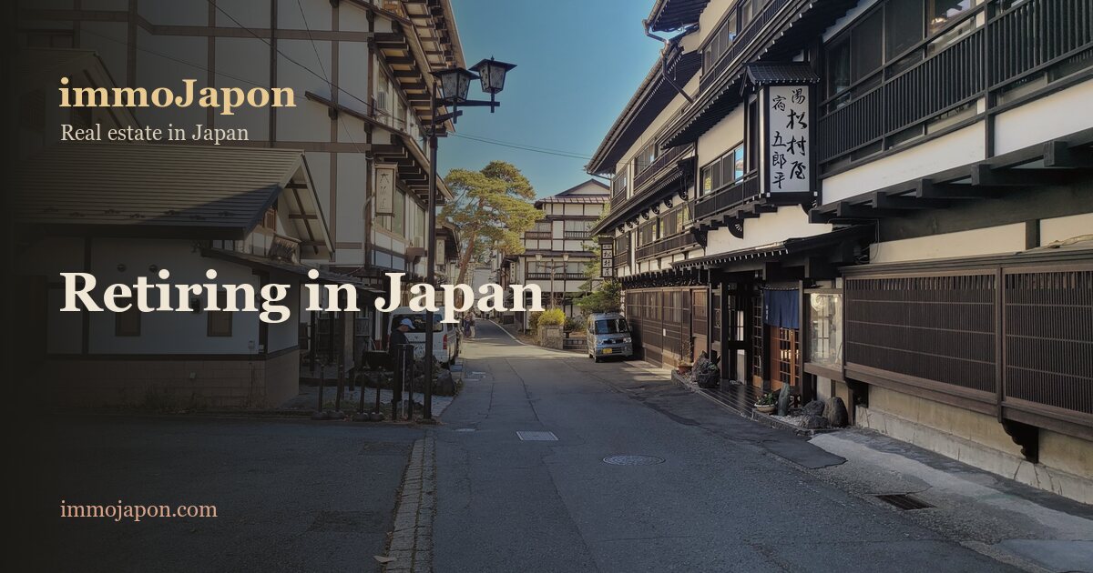Main street of the hot-spring town of Kusatsu in Gunma prefecture: two-storey wooden ryokan inns, wide pavements and an empty road under a clear blue winter sky, an example of the small Japanese towns retirees settle in